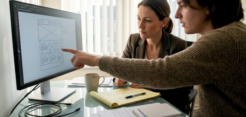 Business owner and designer discuss website layout