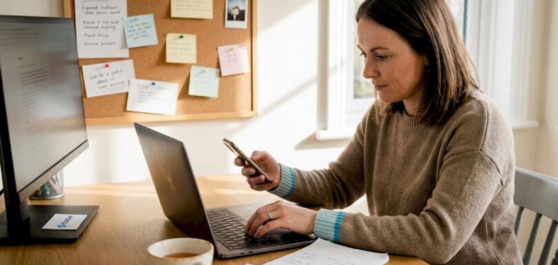 Small business owner managing social media at desk