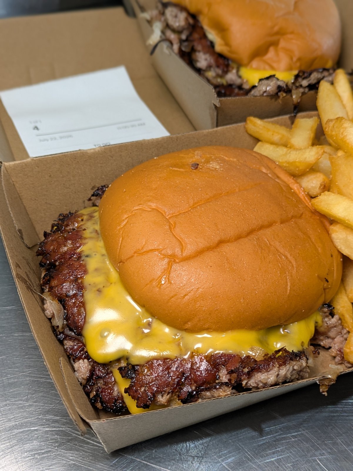 Two Eat at ROBs double smash burgers with fries ready for service
