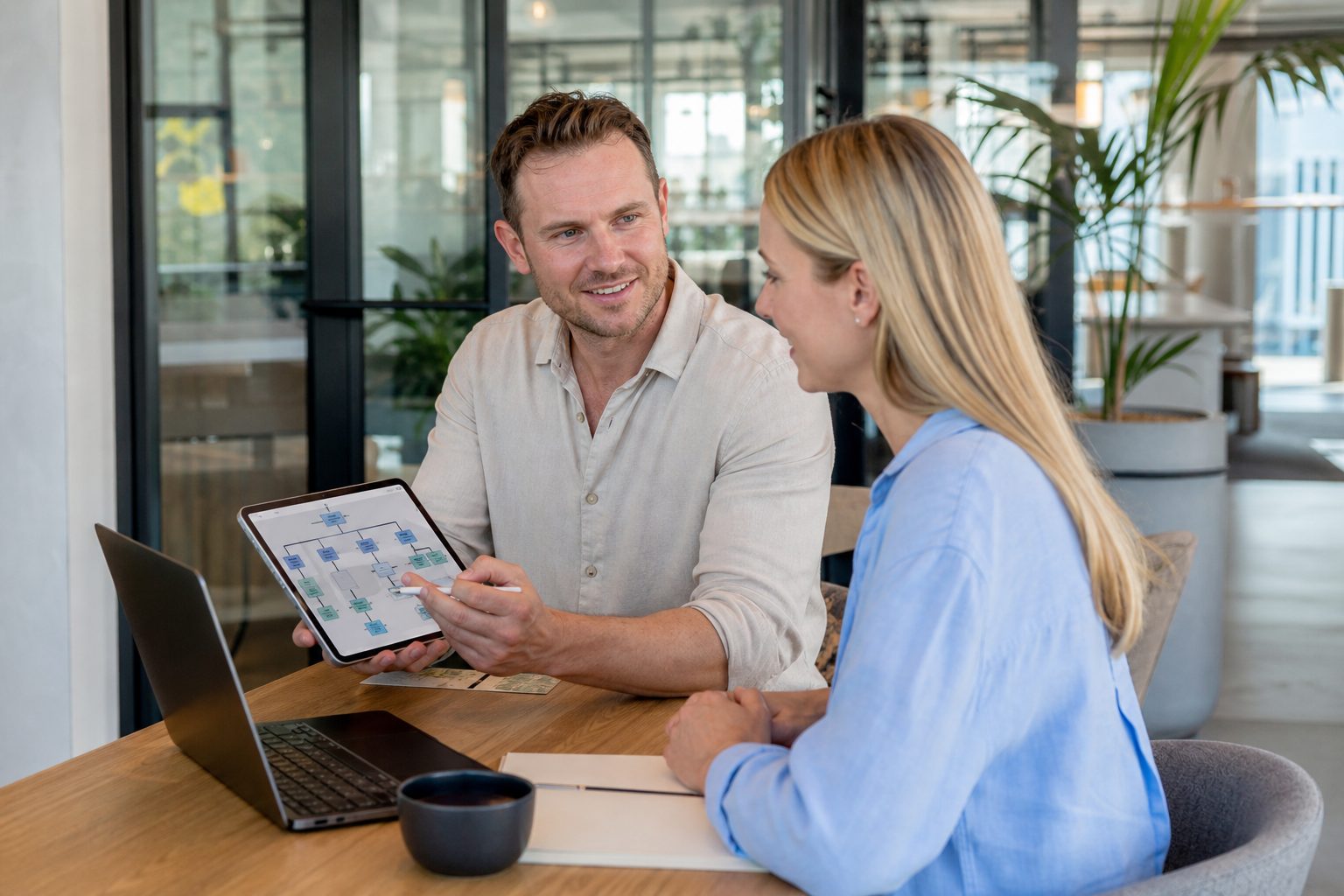 Colleagues reviewing a website structure diagram on a tablet in a Gold Coast coworking space