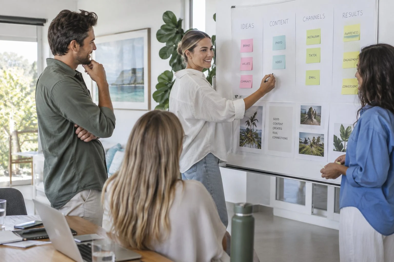 Marketing team planning a content strategy at a whiteboard in a Queensland studio